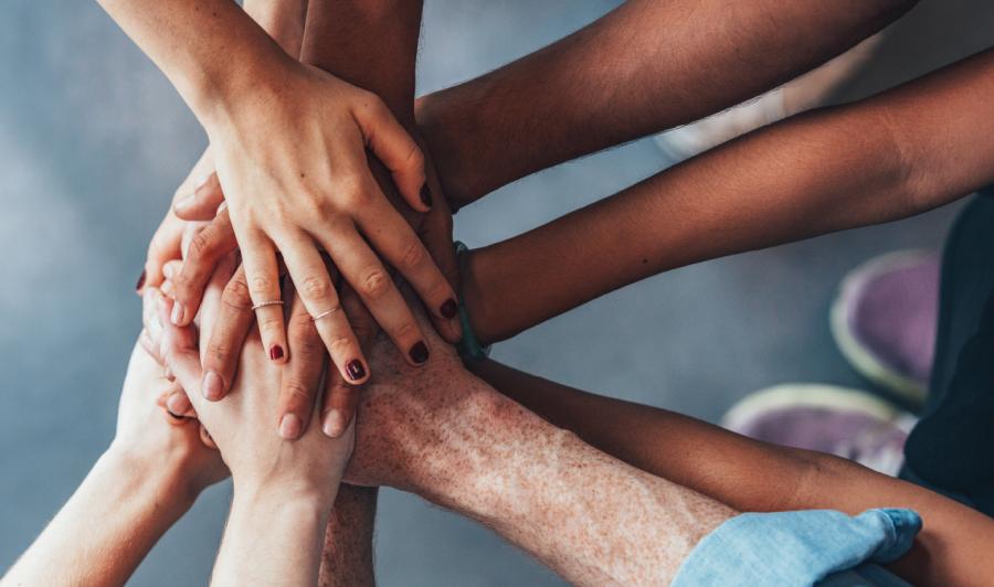 Stack of hands showing unity