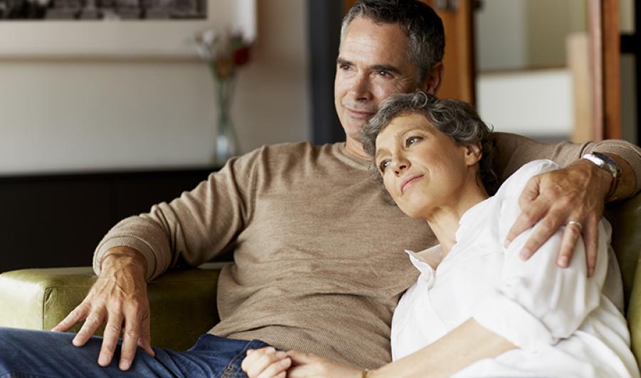 Older white couple relaxing on the couch