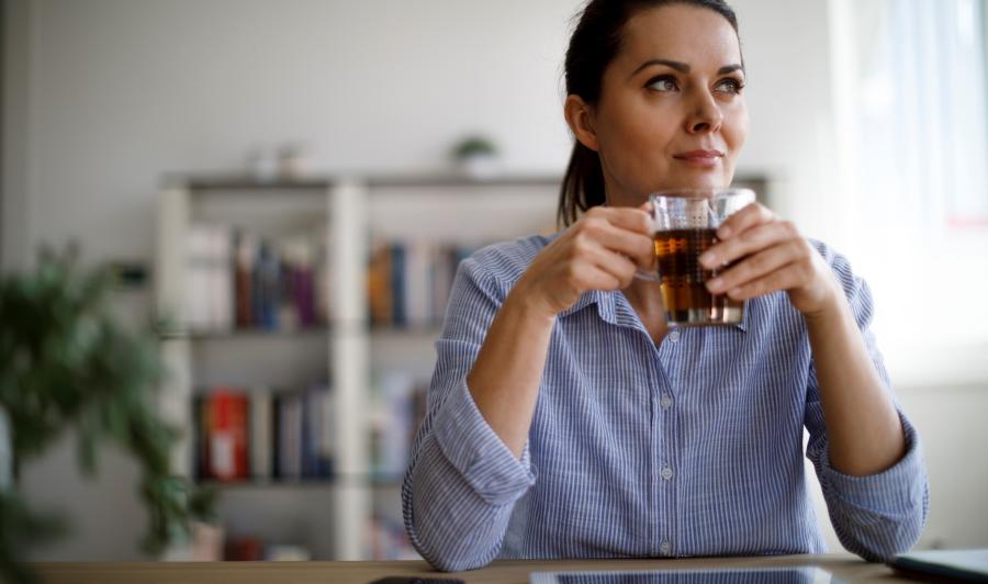 Woman drinking tea in her home