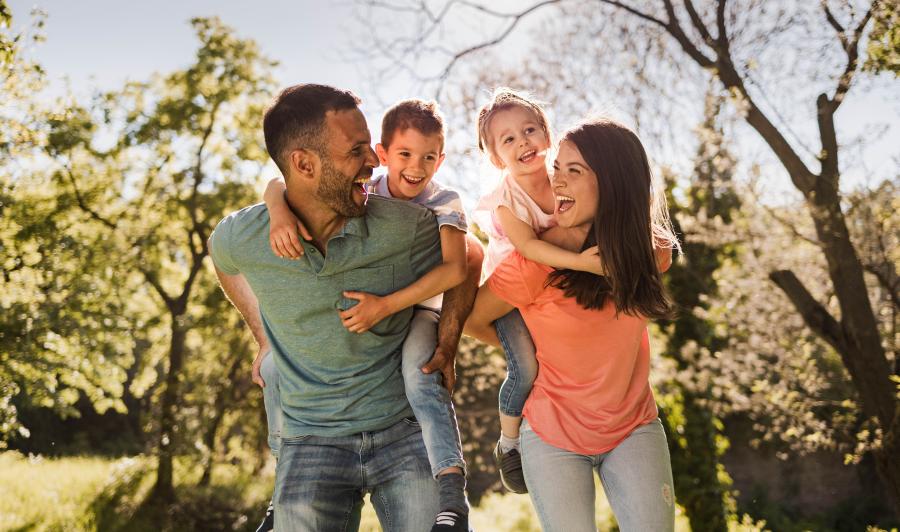 Family plays together in park during Fall