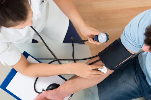 Young doctor checks patient vitals