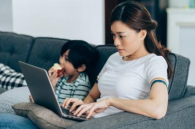 Woman using her laptop to learn more about breast cancer