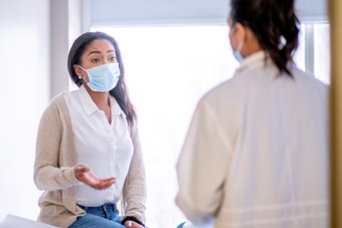 Black female patient speaking with physician