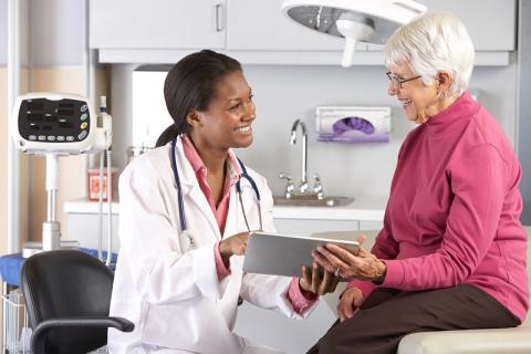 Doctor speaks with patient in exam room