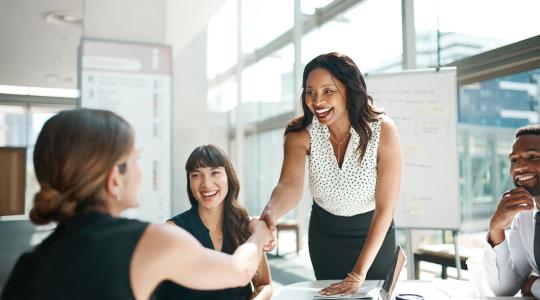 Black woman shaking hands in meeting