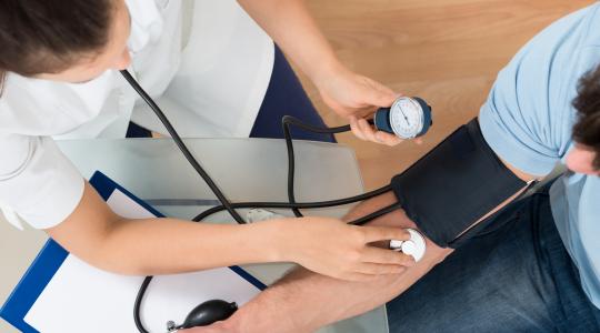 Young doctor checks patient vitals