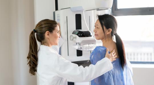 Female doctor administering a mammogram