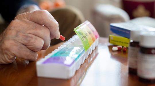 Older man sorting medication